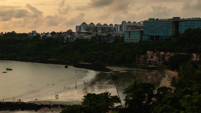 Aerial 4K Timelapse hyper lapse footage of beach activities and landscape at sunset in Dona Paula in Goa