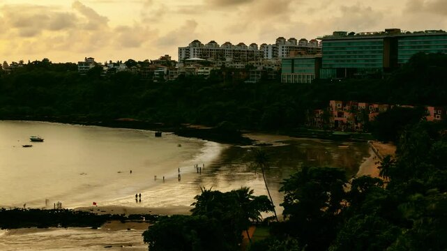 Aerial 4K Timelapse hyper lapse footage of beach activities and landscape at sunset in Dona Paula in Goa
