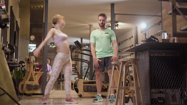 Couple in love dancing bachata and tango. Boy and girl having fun during exercise break in a fitness studio.