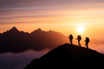 Fototapeta premium Silhouettes of hikers ascend mountain peak during breathtaking s