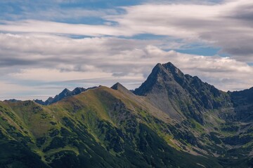 Magical hiking in the Polish Tatras. Tatra Mountain view to group of glacial lakes from path Kasprowy Wierch and to Swinica mount, Poland. Panorama.