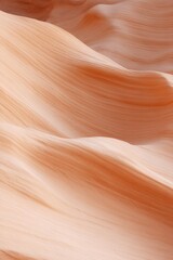 Smooth, flowing layers of soft peach hues create serene, abstrac