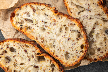 Grain bread sunflower, chia, flax seed, cut oats fresh tasty food dish delicious gourmet food background on the table rustic food top view copy space vegetarian and vegan food