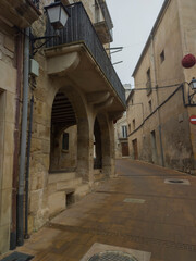 narrow street in the old town; stone houses and streets on a foggy day
