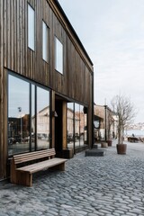 Fototapeta premium Beautifully designed wooden building by the waterfront with modern architecture and tranquil surroundings captured during the early morning hours in a peaceful coastal town