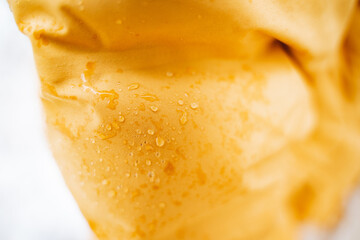 Here is a detailed closeup view of a piece of food, showing the intricate details along with water droplets resting beautifully on its surface, creating an appealing visual