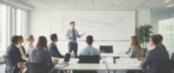 Blurred background of a young professional sharing innovative ideas in front of a corporate team, wide