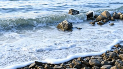 Obraz premium Gently lapping waves on a rocky shore, rocky shoreline, coastal erosion