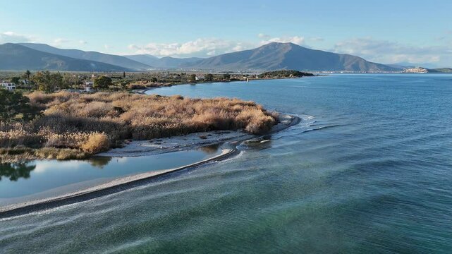 Aerial shot of fresh water inflow into the sea, at the pebble beach of Agios Andreas, Greece