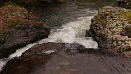 Flowing water of wild river in Winter