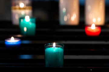 Candles glow in a serene setting at the church during a quiet evening prayer