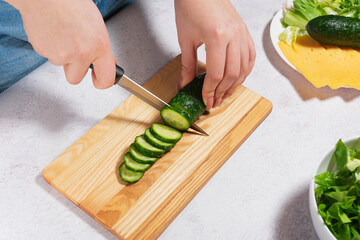 Preparing Fresh Salad with Cucumber