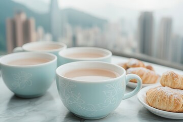 Fototapeta premium Morning break in a foodie city . Cups of tea with pastries overlooking a city skyline.