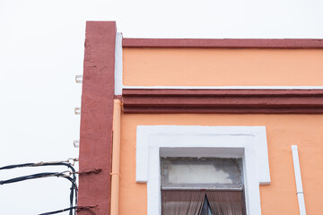 Colorful building facade with wiring in an urban setting on a cloudy day