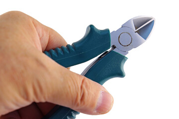 The hand holds electric wire cutters with an insulated handle. Transparent background in PNG.