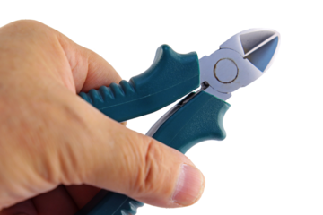 The hand holds electric wire cutters with an insulated handle. Transparent background in PNG.