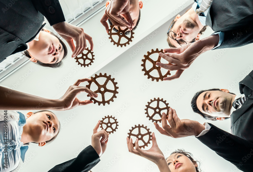 Poster below view group of multiracial business people joining gear wheels together as effective unity and 