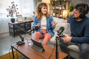 Joyful podcast show hosts record fresh podcast episode in home studio