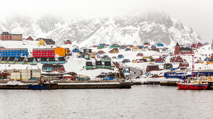 Colorful houses and church on the hill with port in the foreground, Sisimiut city panorama from seaside, Greenland © vadim.nefedov