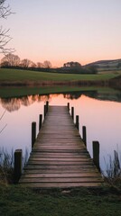 Fototapeta premium A tranquil wooden pier stretches into a serene lake at sunset. Nature reflects beautifully in calm waters. An idyllic setting for relaxation or inspiration. Generative AI