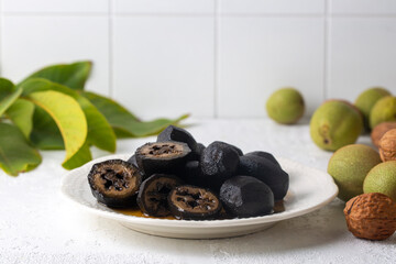 Handmade jam made from green fresh walnuts. Organic walnut jam and walnuts.