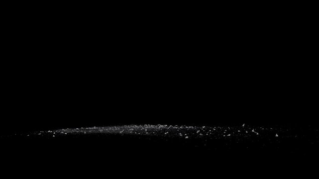 Split Debris Particles Explosion on black png Background. Detonation of stones, meteorites or asteroids. Mining stones fragments flying in slow motion on space.