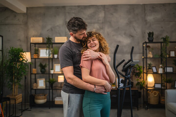 portrait of hugged happy couple in the sports wear together