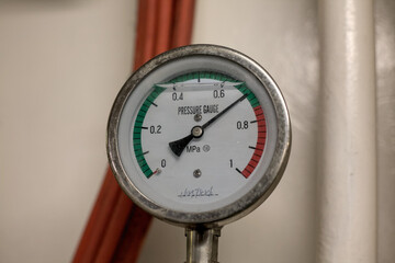 Pressure gauge displays readings in industrial setting showcasing precise measurements and...