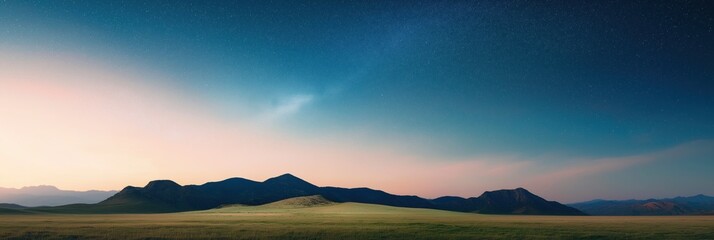 Fototapeta premium A beautiful night sky with a large mountain range in the background. The stars are shining brightly, creating a peaceful and serene atmosphere