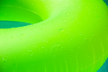 Summer vacation. Relaxing at pool. Summer resort vacation. Recreation concept. Inflatable ring in swimming pool. Swimming bright ring. Fun in pool. Inflatable ring at poolside. Sunlit pool afternoons