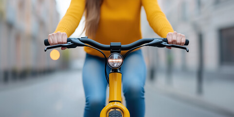 Woman wearing casual clothes rides a yellow electric bicycle in a city street, embracing sustainable transportation and enjoying a healthy lifestyle