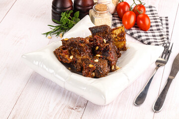 Prepared tasty beef ribs with sauce