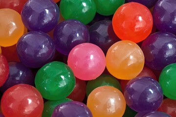 A close-up shot of a collection of gummy balls in various colors and shapes