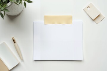 Blank mockup with a white sheet, adhesive tape, and stationery items on a clean surface. Paper with deckle edge