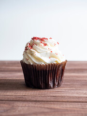 closeup of delicious cupcake on wooden background