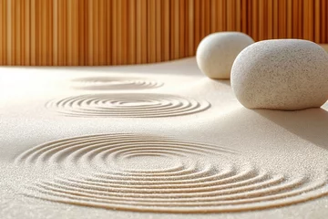 Sandy zen garden with calm concentric circles. Natural beige sand texture creates peaceful background. Two round stones placed on sand. Ideal for spa, meditation, relaxation concepts. Minimalist