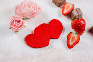 Fototapeta premium Valentines Day card with flowers chocolates and strawberries.