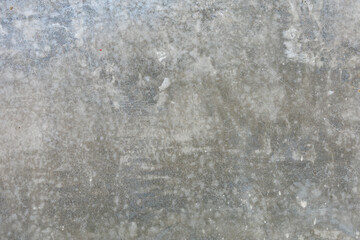 Close-up of weathered gray concrete surface with texture and patterns