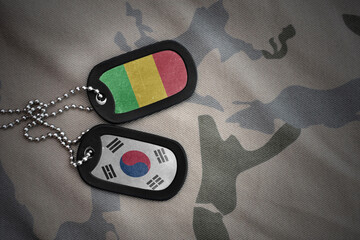 vintage army blank, dog tag with flag of mali and south korea on the khaki texture background....