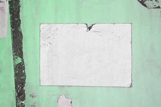 Old white creased crumpled poster background glued on green old ripped torn paper backdrop surface placard empty space for text frame