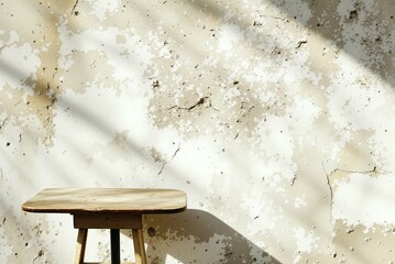 a wooden stool sitting against a wall