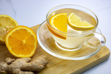 Fresh ginger root tea with lemon and orange slices.