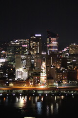 Fototapeta premium Birds eye view of the city skyline of downtown Pittsburgh, Pennsylvania at night.