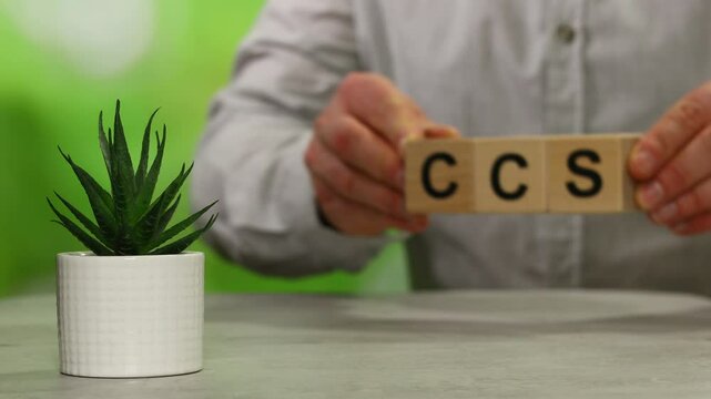 Wooden cubes form the symbol CCS (carbon capture storage) and CCU (carbon capture utilization). Environmental Business concept, Net zero action, Save energy, green energy, reduce carbon footprint