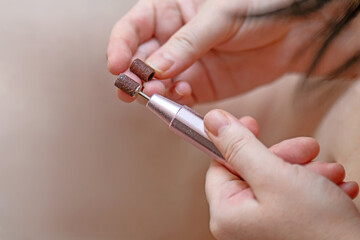 women's hands comparing the coarseness of abrasive coatings on nail and skin cleaning attachments. Perfect for beauty, nail care, and personal grooming themes