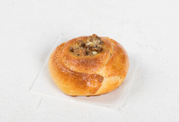 Small Open pie filled with fish, eggs and onions. White background. Close up