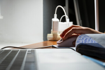 Fototapeta premium Computer mouse and laptop, freelance work environment
