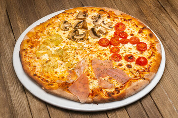 Homemade pizza with cherry tomato, artichoke, serrano ham and mushrooms