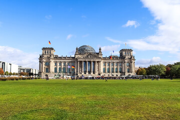 Reichstag building with german flags waving in Berlin, Germany © Michael