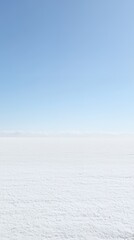 Vast Winter Landscape: A Serene Snowscape Under a Clear Blue Sky